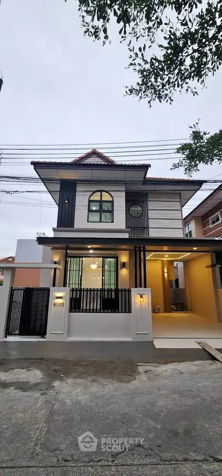 Modern two-story house with stylish facade and gated entrance