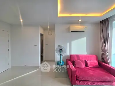 Modern living room with vibrant pink sofa and sleek air conditioning unit.