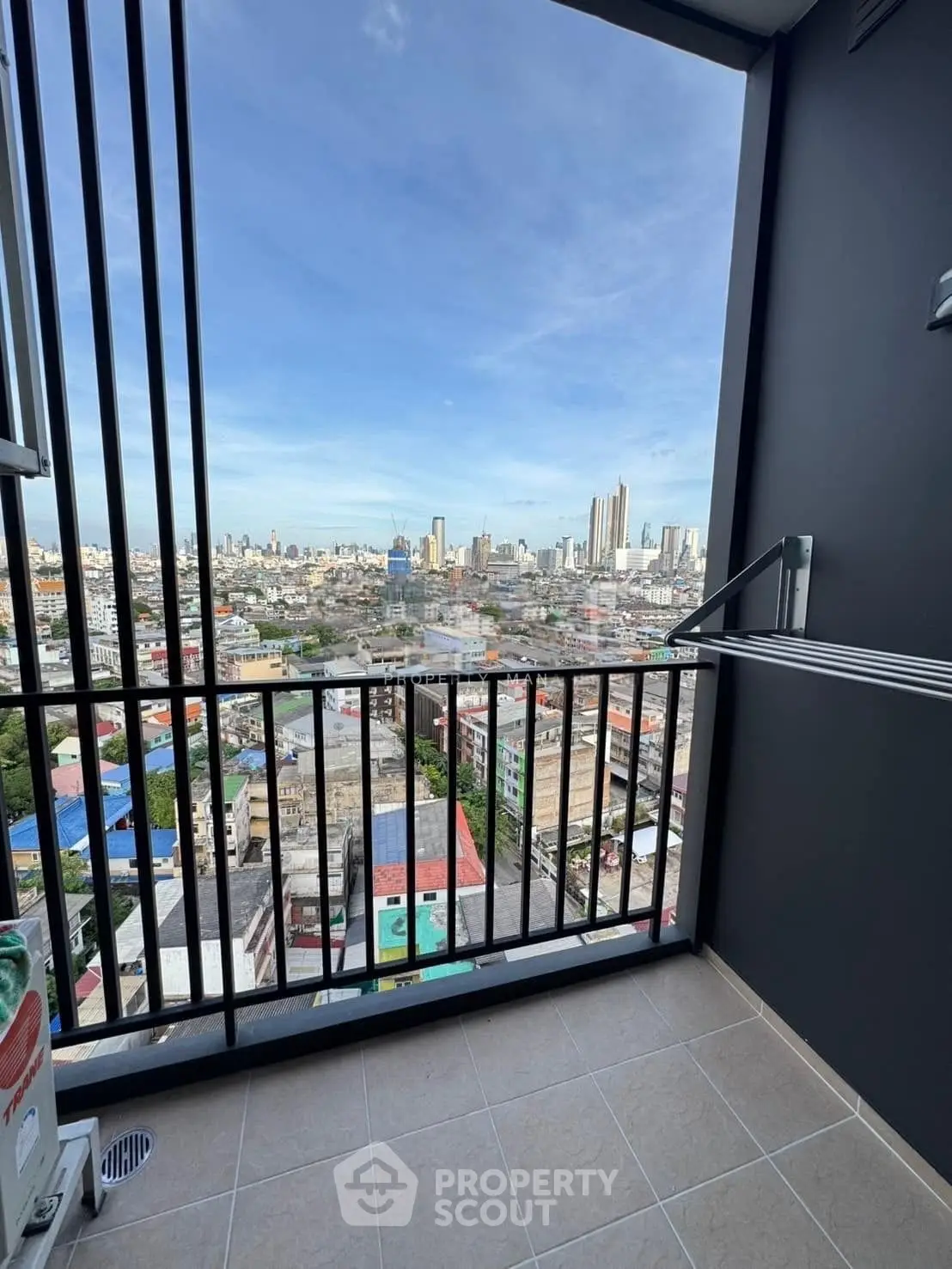 Stunning cityscape view from a modern balcony with sleek railing design.