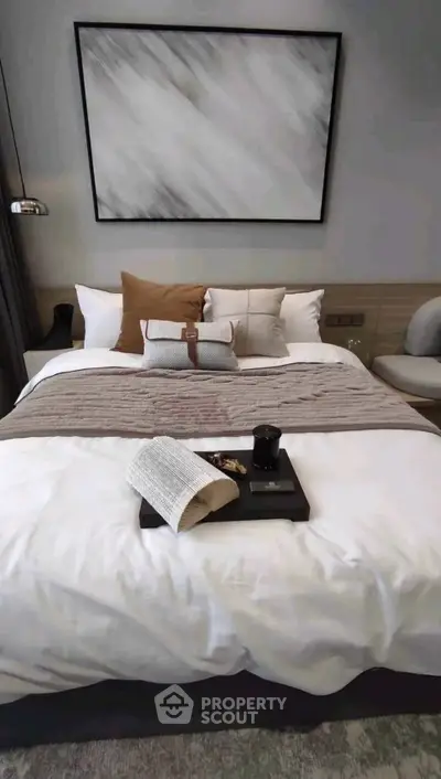 Luxurious bedroom with stylish decor and cozy bedding in modern apartment.