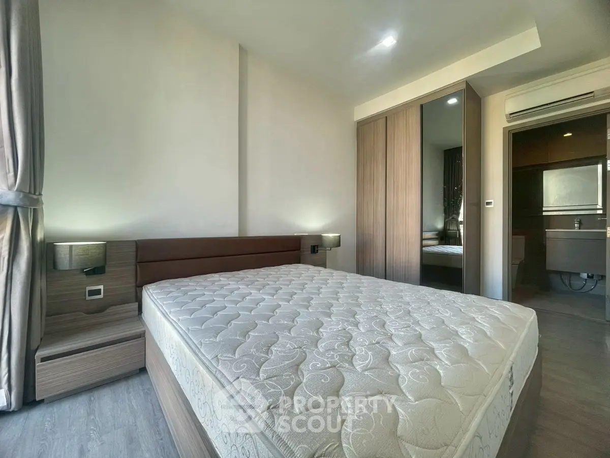 Modern bedroom with large bed and built-in wardrobe, featuring sleek design and ample natural light.
