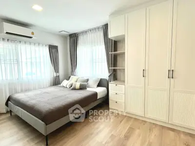 Spacious bedroom with modern decor and ample natural light