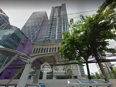 Stunning high-rise building with modern architecture and lush greenery in urban setting.