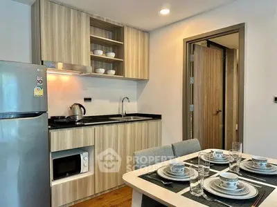 Modern kitchen with dining area featuring sleek appliances and stylish cabinetry.