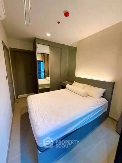 Modern bedroom with sleek design and ample storage in a stylish apartment.