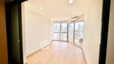 Bright empty room with city view and large windows in modern apartment.