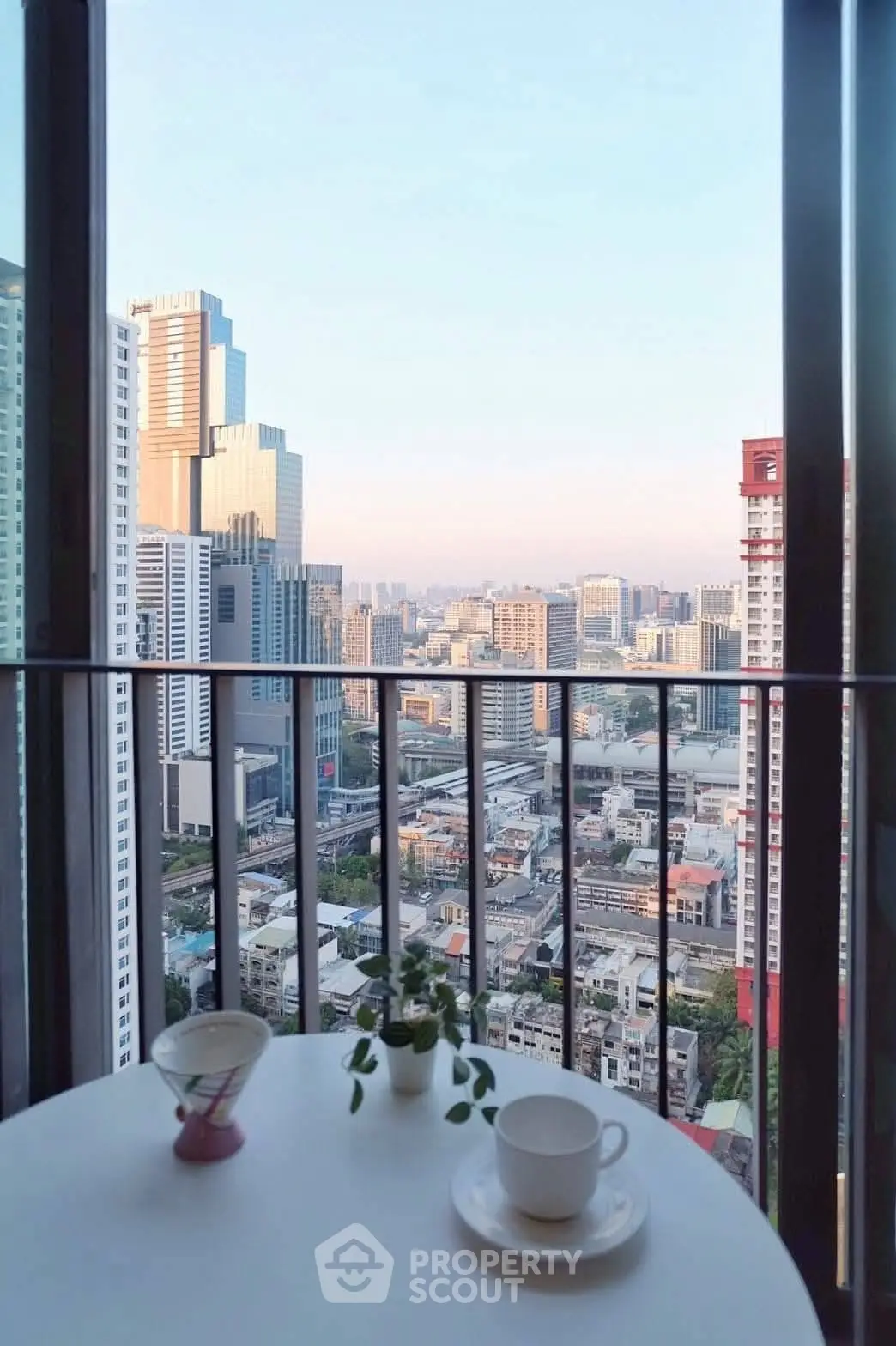 Stunning city view from a high-rise balcony with modern skyline backdrop.