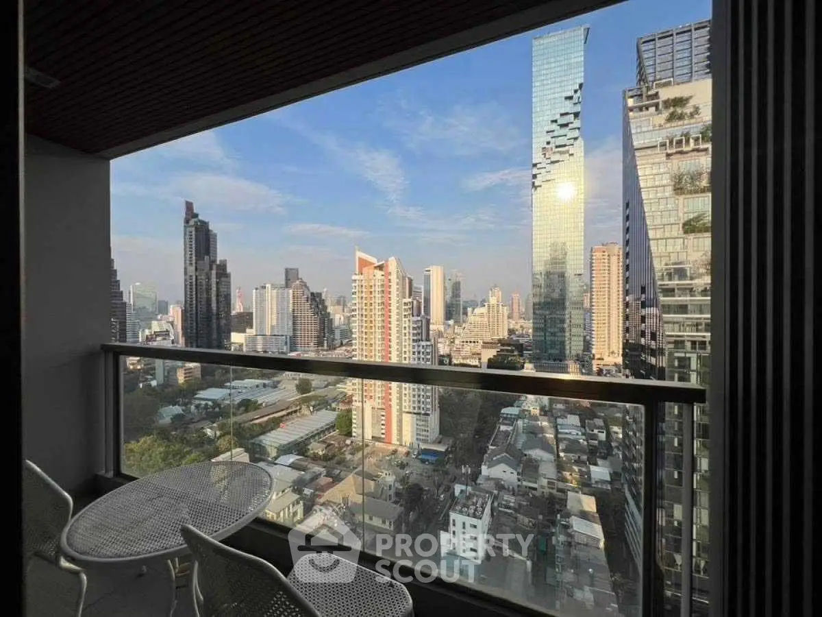 Stunning cityscape view from a modern balcony with stylish outdoor seating.