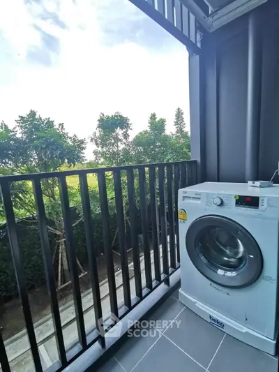 Charming balcony with lush greenery view and modern washing machine, perfect for urban living.