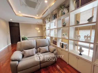 Luxurious living room with elegant shelving and plush seating in modern apartment.