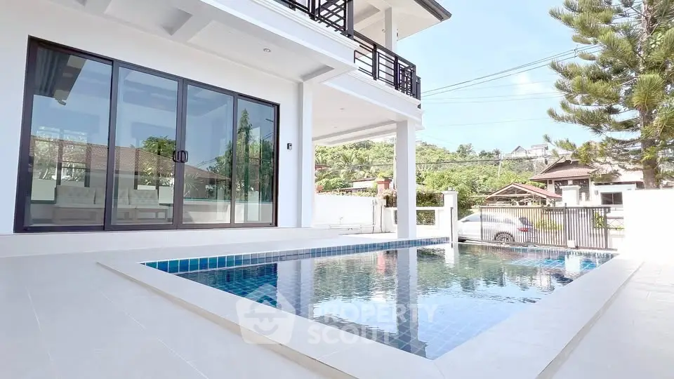 Luxurious modern home with private pool and spacious patio area.