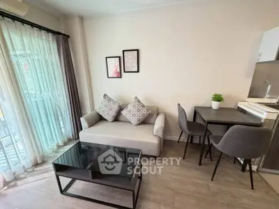 Modern living room with cozy sofa, glass coffee table, and dining area