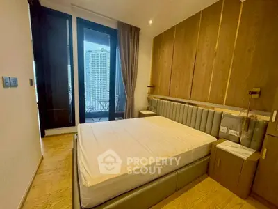 Modern bedroom with wooden accents and city view balcony access