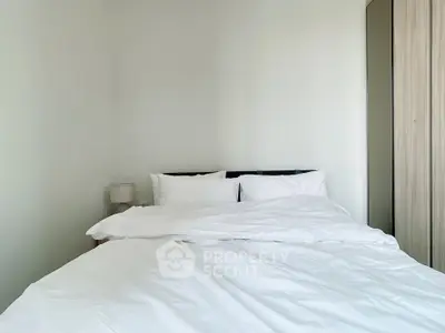 Cozy minimalist bedroom with white bedding and modern wardrobe