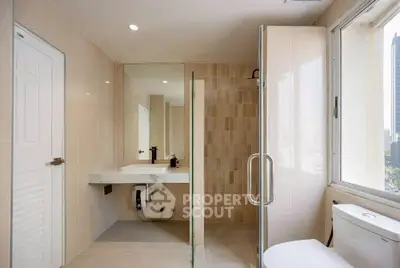 Modern bathroom with glass shower and city view window