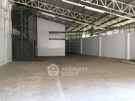 Spacious industrial warehouse with high ceilings and ample storage space.