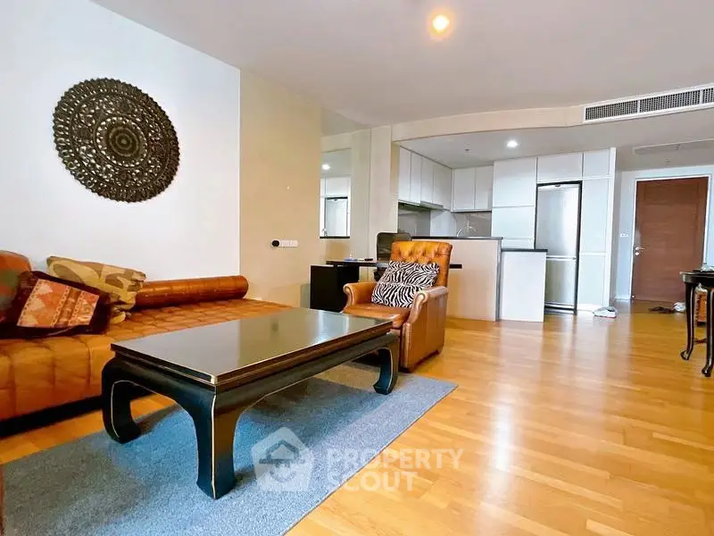 Spacious living room with modern decor and open kitchen layout