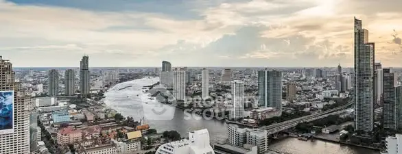 Stunning cityscape view with river and skyscrapers at sunset.