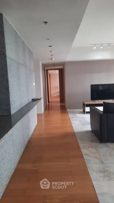 Spacious modern living room with sleek design and hardwood flooring
