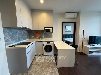 Modern kitchen with sleek appliances and open layout in stylish apartment