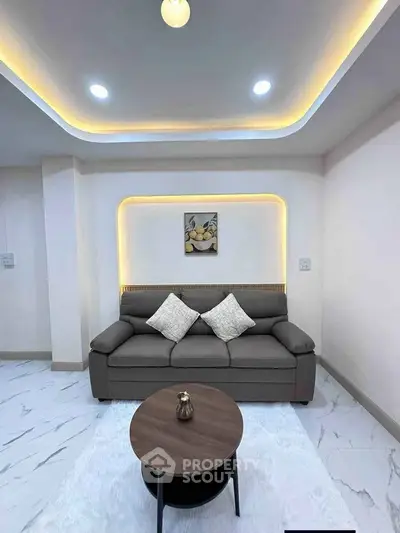 Modern living room with stylish sofa and ambient lighting, perfect for relaxation and entertaining.