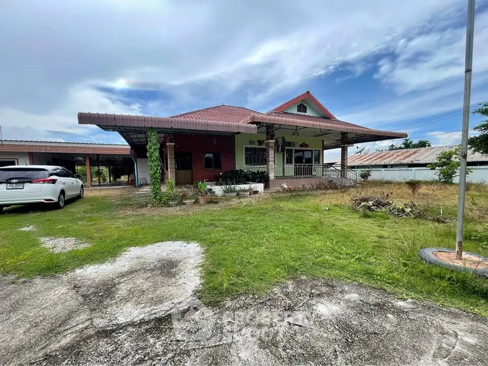 Charming single-story house with spacious yard and carport, perfect for family living.