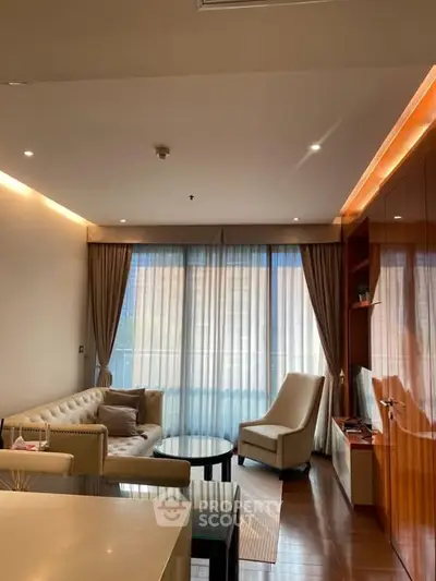 Elegant living room with modern furniture and large windows offering natural light.