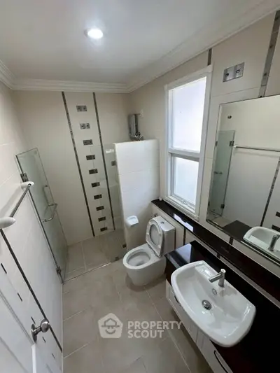 Modern bathroom with sleek fixtures and glass shower enclosure