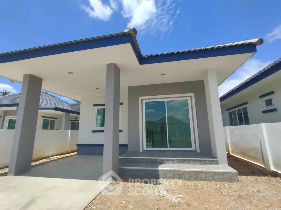 Charming modern single-story house with sleek design and spacious front porch.
