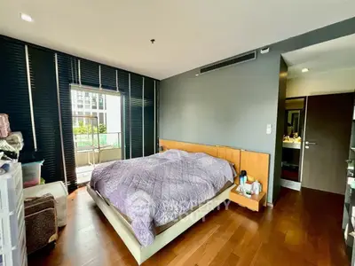 Spacious bedroom with balcony access and modern decor in a stylish apartment.