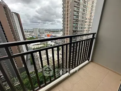 Spacious balcony with stunning cityscape view in modern high-rise apartment.