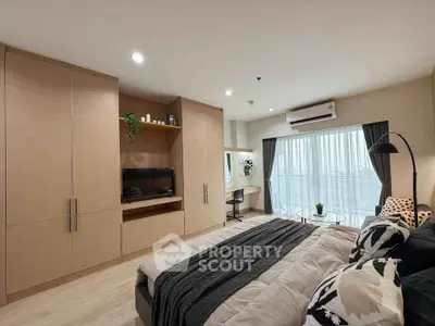Modern bedroom with built-in wardrobe, cozy bed, and natural light from large window.