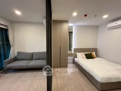 Modern studio apartment with cozy bed and stylish sofa