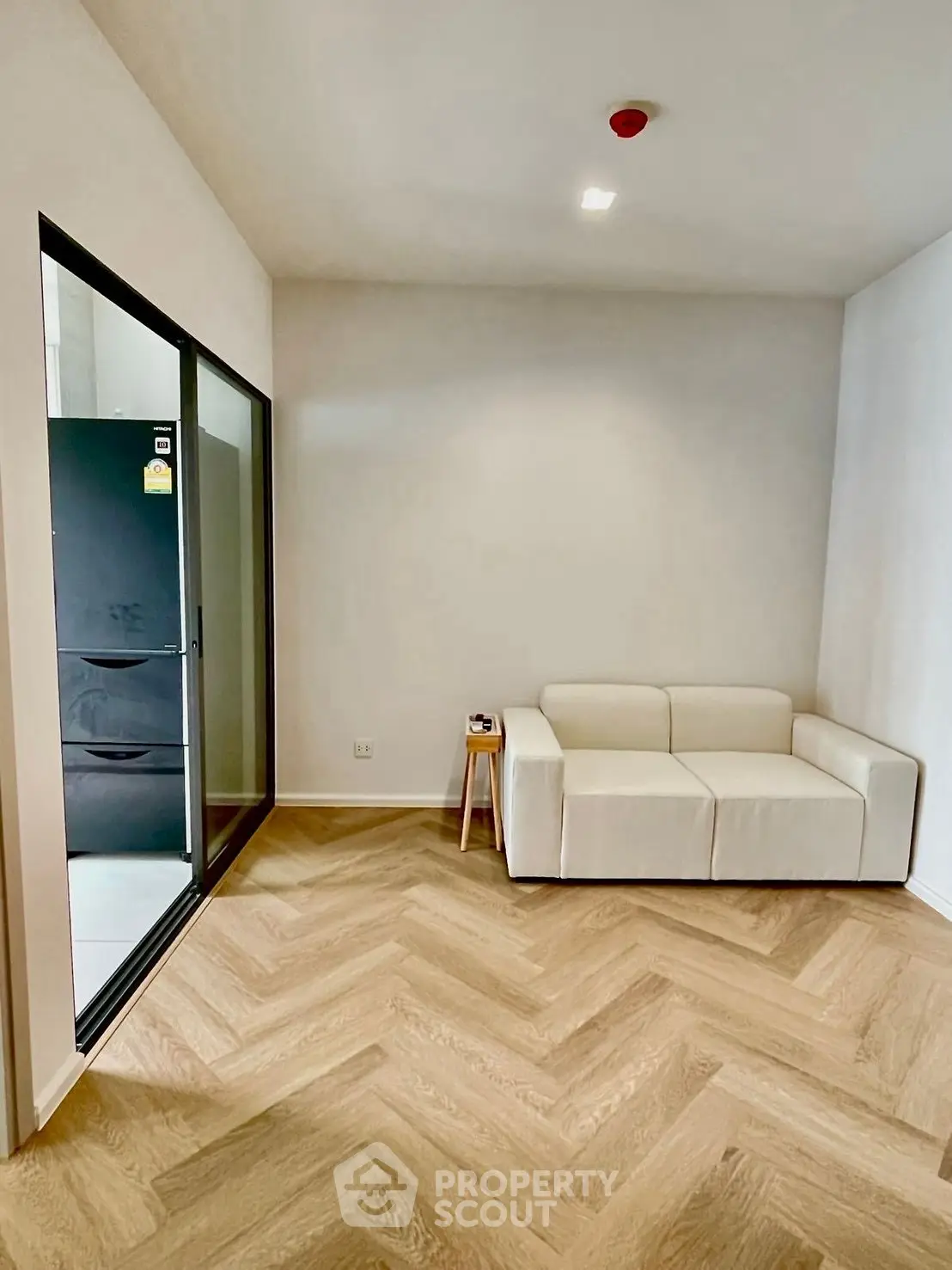 Modern living room with elegant herringbone flooring and cozy white sofa