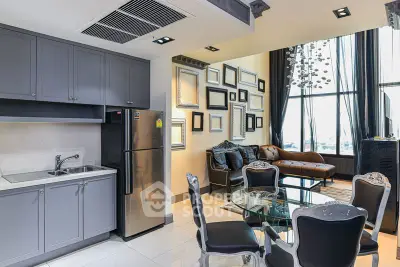 Modern open-plan kitchen and living area with stylish decor and large windows.