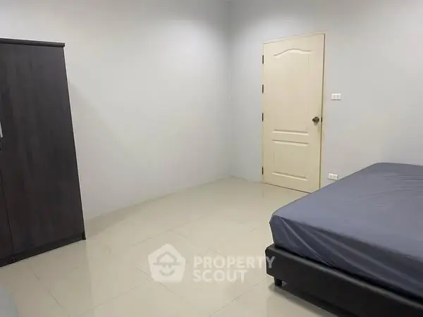 Spacious minimalist bedroom with modern wardrobe and bed