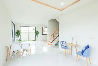 Bright and modern living room with stylish furniture and staircase, perfect for contemporary living.