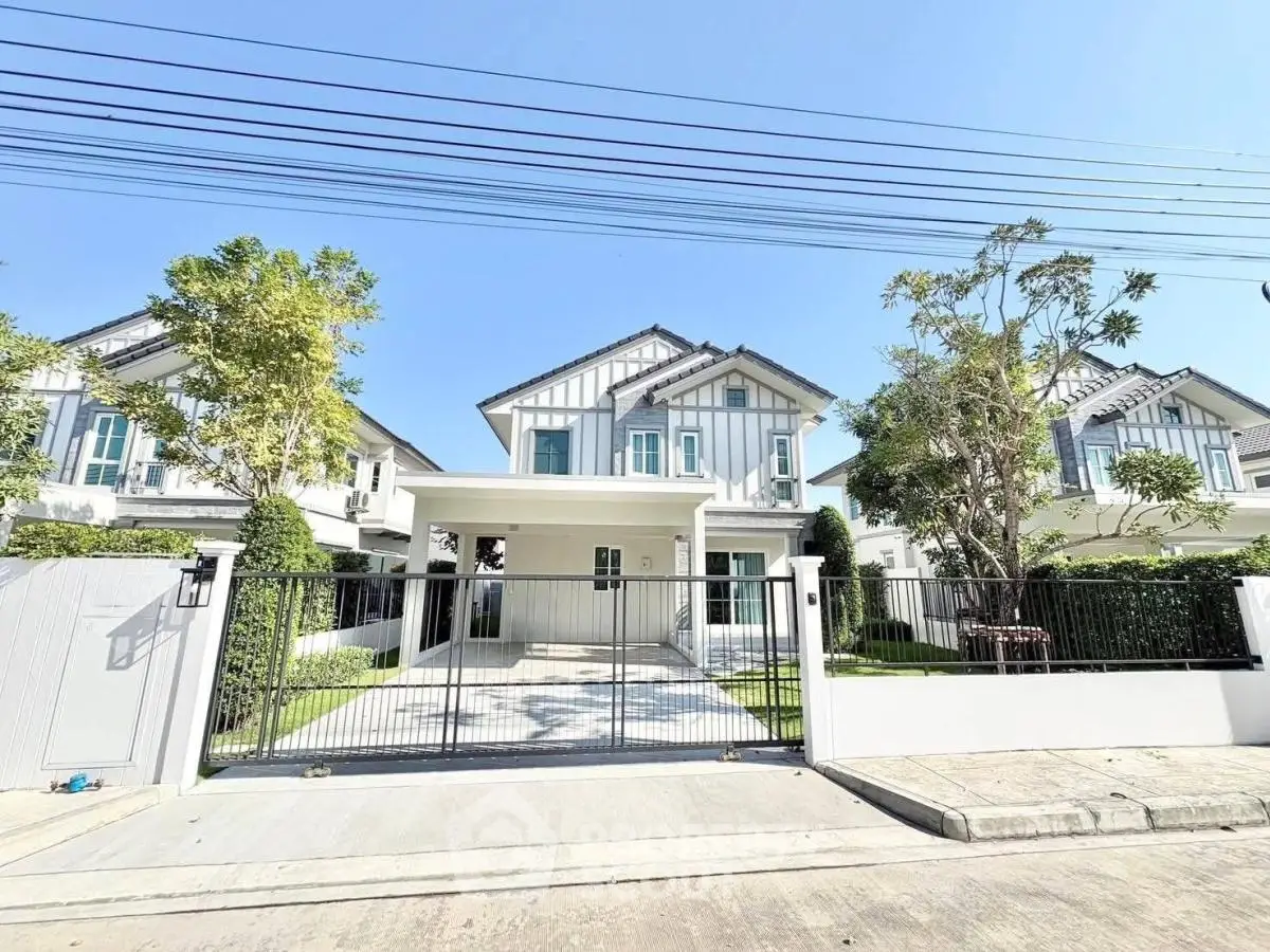 Charming modern house with spacious driveway and lush garden in serene neighborhood.
