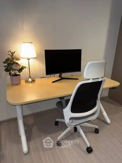 Modern home office setup with sleek desk, ergonomic chair, and stylish lamp.