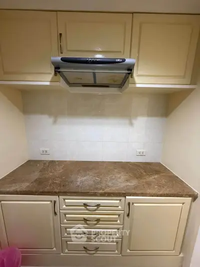 Charming kitchen with marble countertop and ample storage space