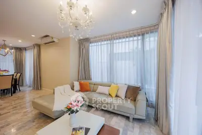Elegant living room with chandelier and cozy sofa in modern home