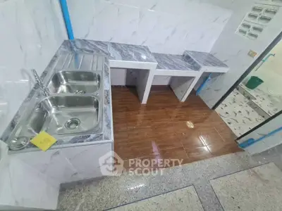 Modern kitchen with dual stainless steel sinks and marble countertops