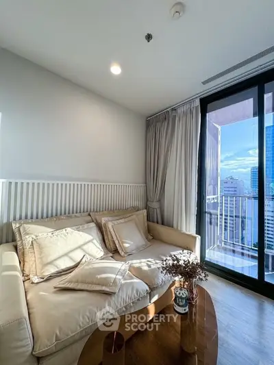Chic living room with cozy sofa and city view balcony in modern apartment