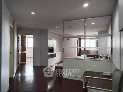 Spacious living room with modern decor and open layout, featuring hardwood floors and ample natural light.
