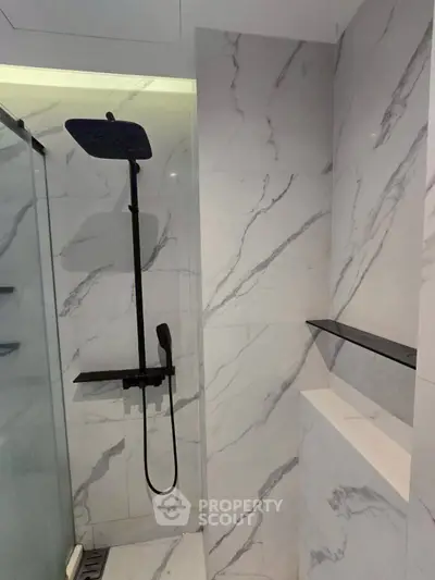 Modern bathroom with sleek marble tiles and rainfall showerhead