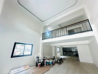 Spacious modern interior with high ceilings and mezzanine, ideal for creative living or office space.