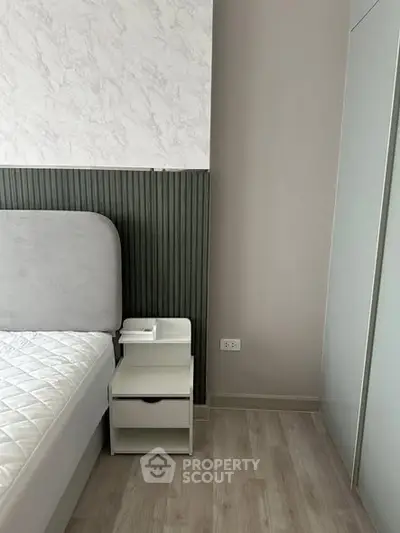 Modern bedroom with stylish headboard and sleek wardrobe design