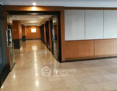 Spacious and elegant building corridor with polished floors and modern design.