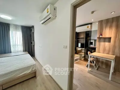 Modern bedroom with study area, featuring sleek furniture and natural light.