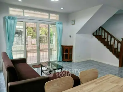 Spacious living room with modern furniture and large windows in a stylish home.